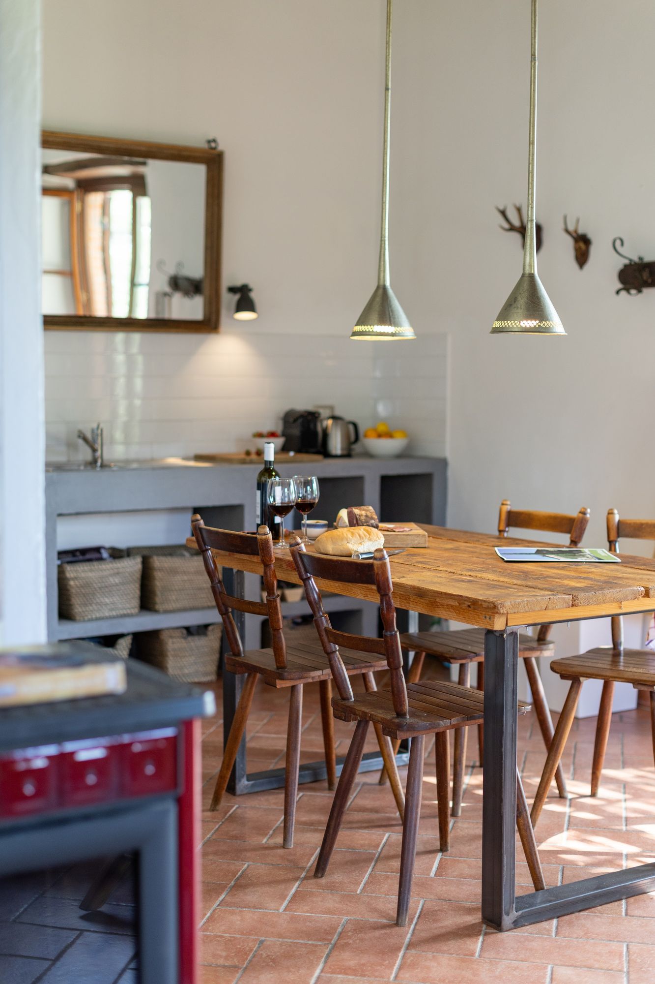 Long wooden dining table under pendant lights