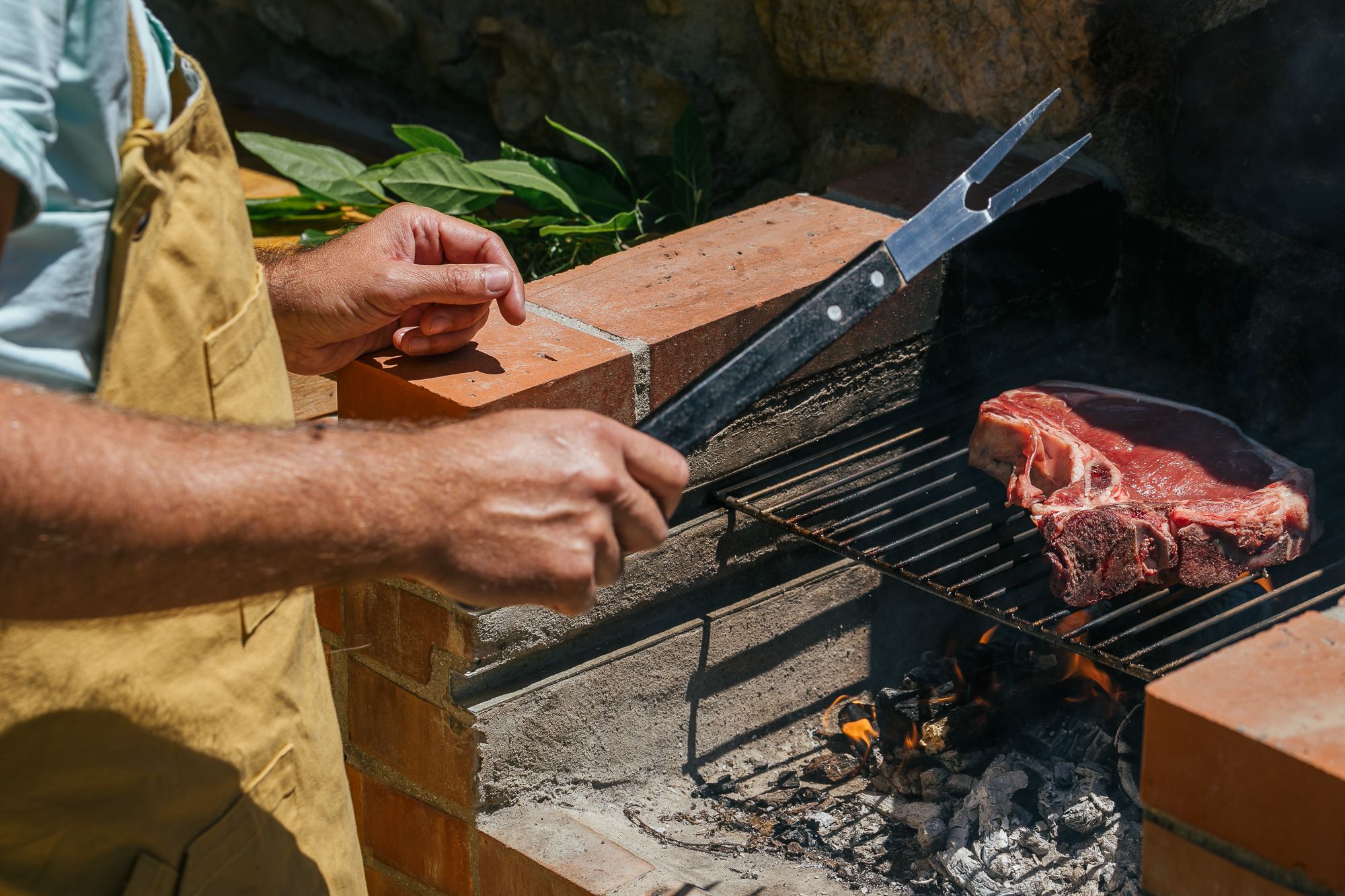 Meat over the wood fire of the outdoor kitchen at Casa Campori