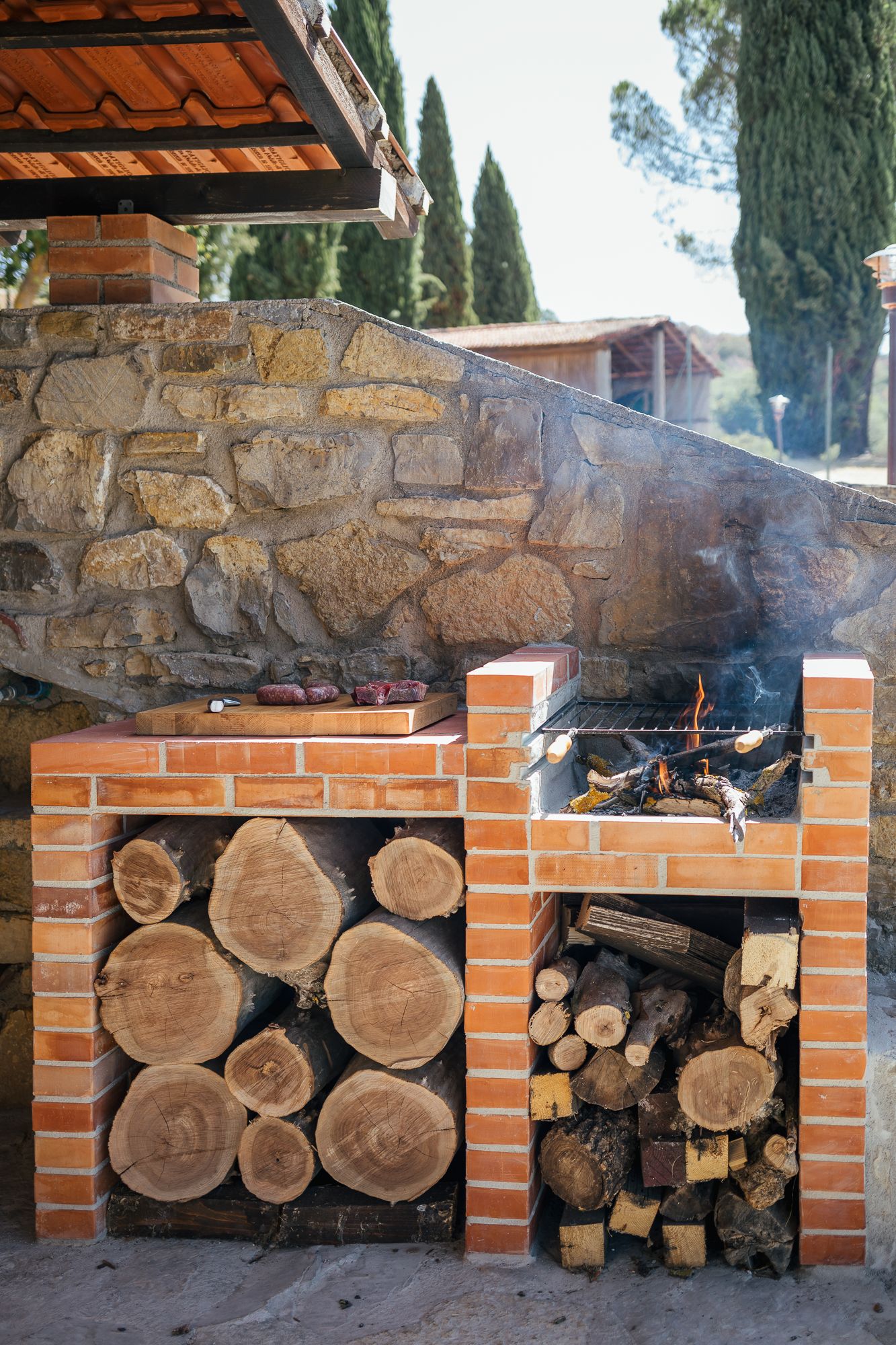 Wood fire burning in the outdoor kitchen before dinner