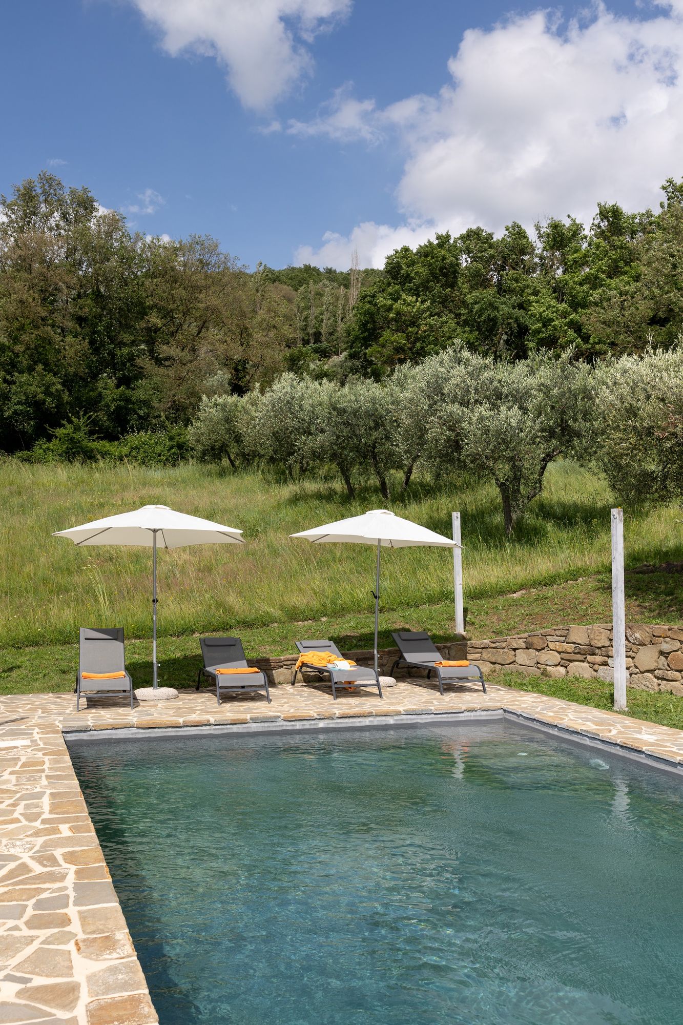 Clear pool water meeting the natural stone surround